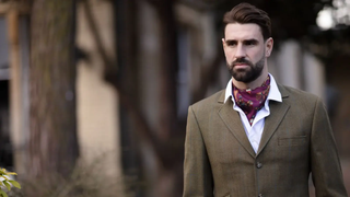Men's pure silk cravat, in mulberry, worn by a gentlemen in country clothing, standing in the woods