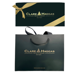 Clare Haggas gift wrap and packaging with signature black box and gold ribbon, and a black luxury rope handle bag