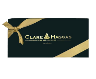 Clare Haggas gift wrap and packaging with signature black box and gold ribbon
