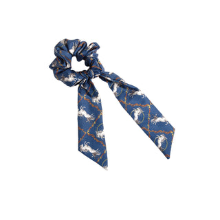 Luxury navy blue scrunchie with tails, showing a designer horse pattern, displayed on a white background